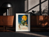 Black-framed Witch riding broomstick past moon print on a moody console with designer coffee-table books