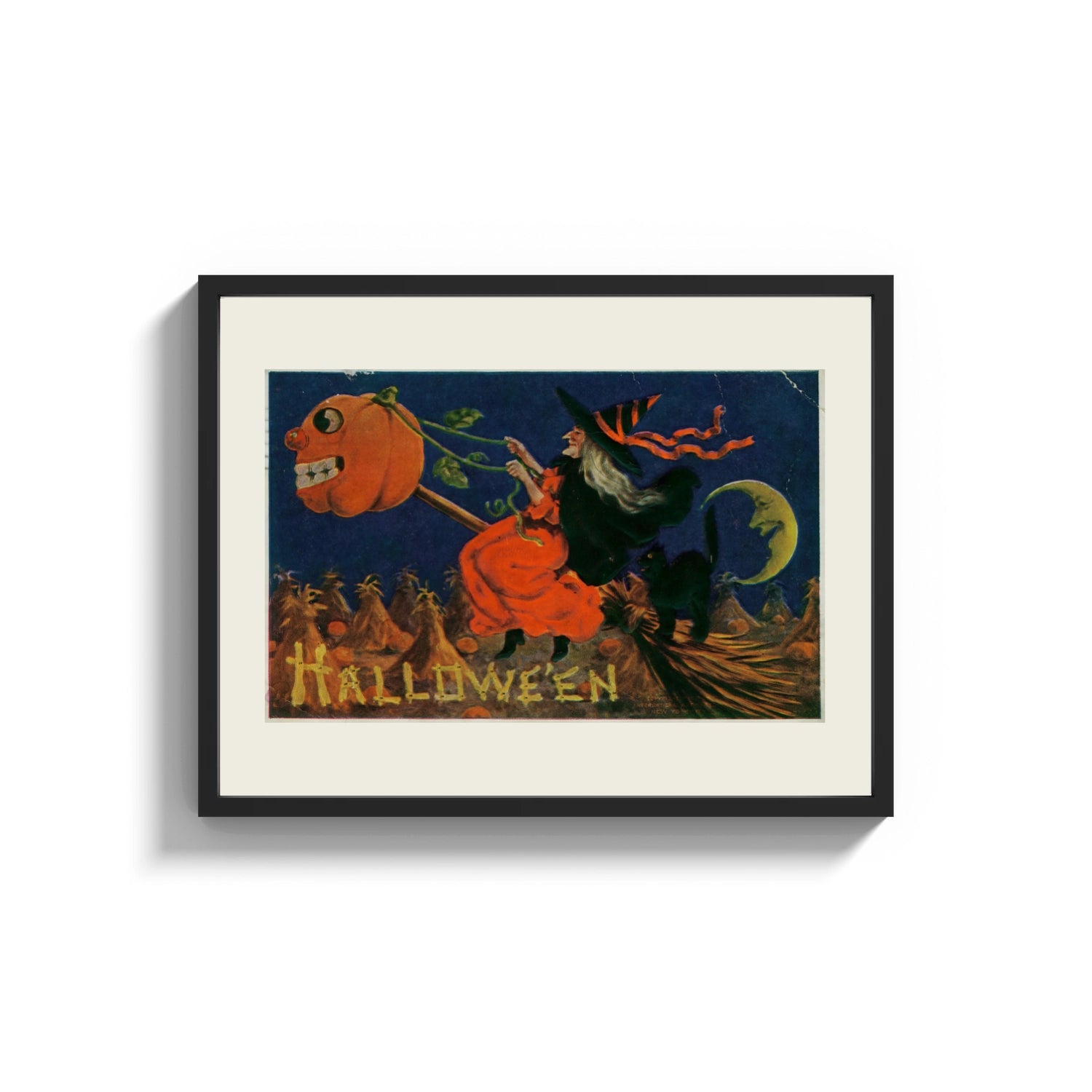 Framed Witch flying on broomstick with pumpkin print shown as a wide statement piece on a clean white wall