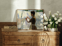 Woman hanging laundry outdoors print in an oak frame on a farmhouse dresser beside white tulips