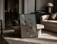 Woman in Heart Hoops and Sunglasses print on the floor, leaning against a travertine table