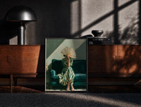 Black-framed Woman with a Fan in Green Stripes print on the floor in front of a dark wooden console