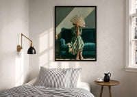 Woman with a Fan in Green Stripes print in a black frame above a bed with striped linens