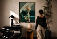 Woman with a Fan in Green Stripes print in a black frame on a sunlit plaster wall, a woman looking on beside a mushroom lamp