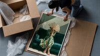 Woman with a Fan in Green Stripes framed print being unpacked from protective bubble wrap and a box
