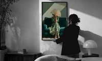 Woman with a Fan in Green Stripes print in a slim black frame being hung on a sunlit wall in a monochrome room