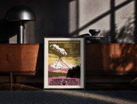 Black-framed Erupting volcano over lake print on a moody console with designer coffee-table books