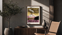Erupting volcano over lake poster framed above a fluted sideboard beside an olive tree
