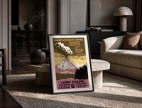 Erupting volcano over lake print in a black frame leaning on a travertine table in a sunlit lounge
