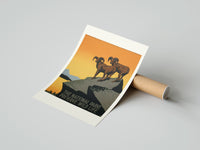 Rolled Two bighorn sheep on rocky cliff poster beside its crush-resistant kraft shipping tube
