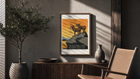 Two bighorn sheep on rocky cliff poster framed above a fluted sideboard beside an olive tree