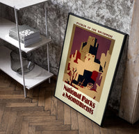 Southwest pueblo cliff dwellings poster in a black frame leaning beside a shelf in a raw-plaster loft