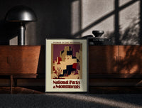 Black-framed Southwest pueblo cliff dwellings print on a moody console with designer coffee-table books