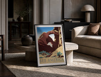 Desert rock arch with riders print in a black frame leaning on a travertine table in a sunlit lounge