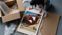 Desert rock arch with riders framed print being unpacked from protective bubble wrap and a box