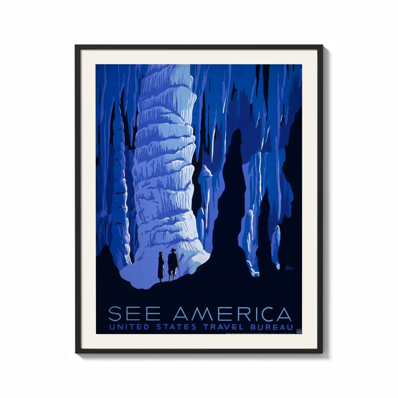 Framed Cave stalactites with two tourists print shown as a bold statement piece on a clean gallery wall