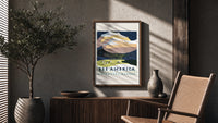Snowy mountain with Native American camp poster framed above a fluted sideboard beside an olive tree