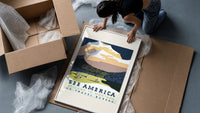 Snowy mountain with Native American camp framed print being unpacked from protective bubble wrap and a box