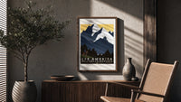 Cowboy on horse viewing mountains poster framed above a fluted sideboard beside an olive tree
