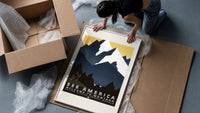 Cowboy on horse viewing mountains framed print being unpacked from protective bubble wrap and a box